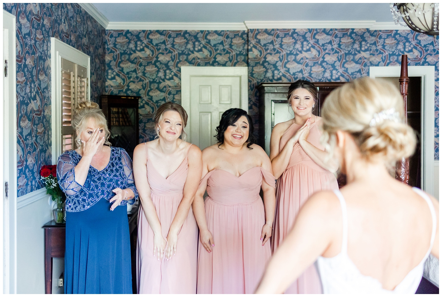 bridesmaids seeing bride for first time in wedding gown