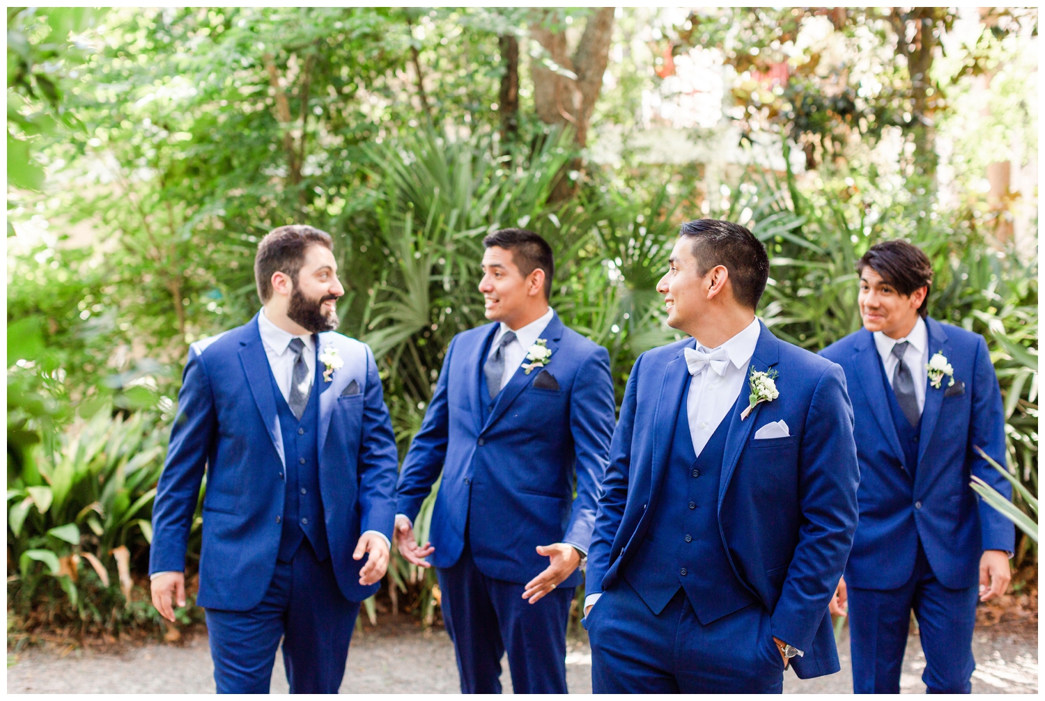 groom and groomsmen walking wearing blue suits southern summer wedding Charleston