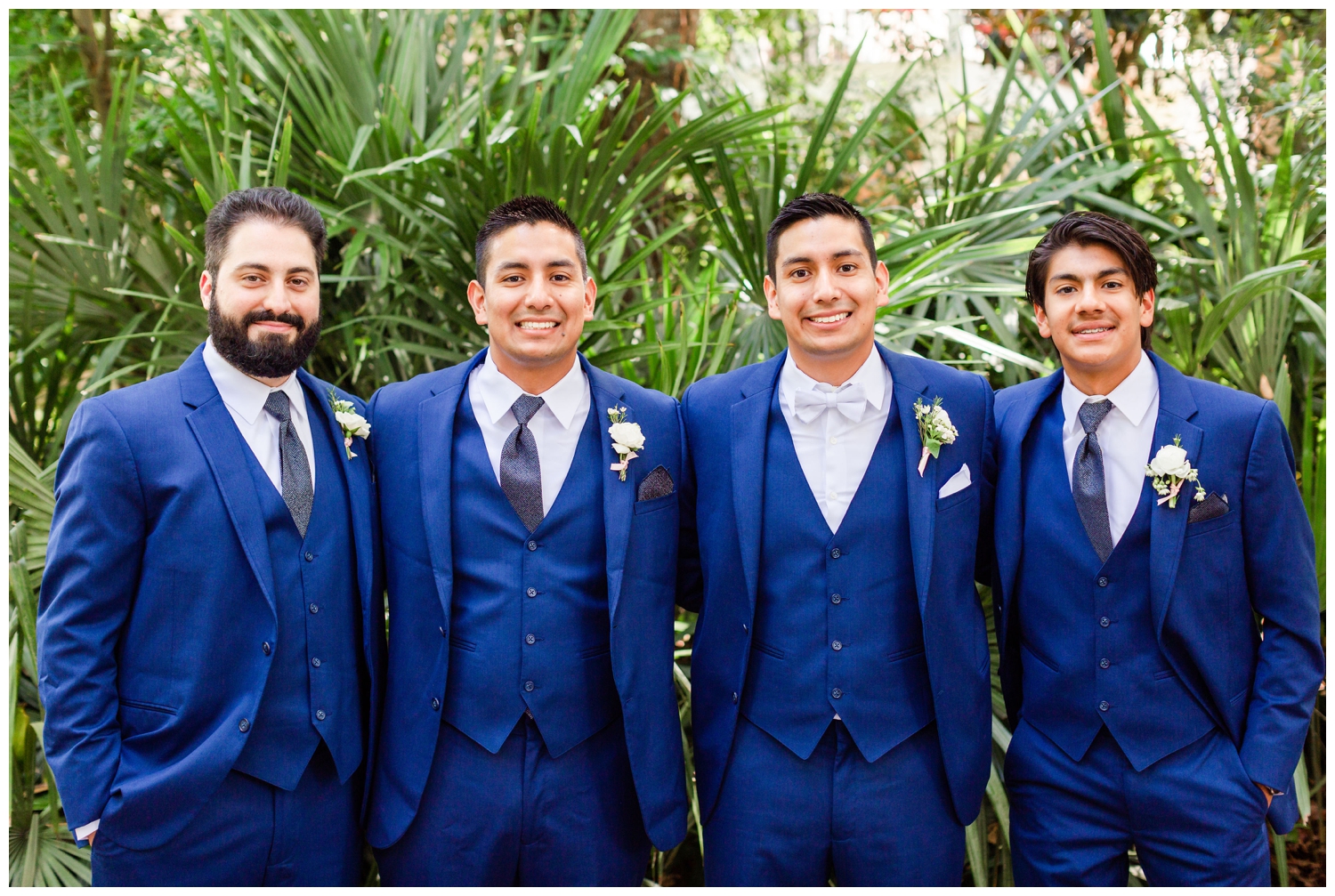 groom posing with groomsmen outside for portraits