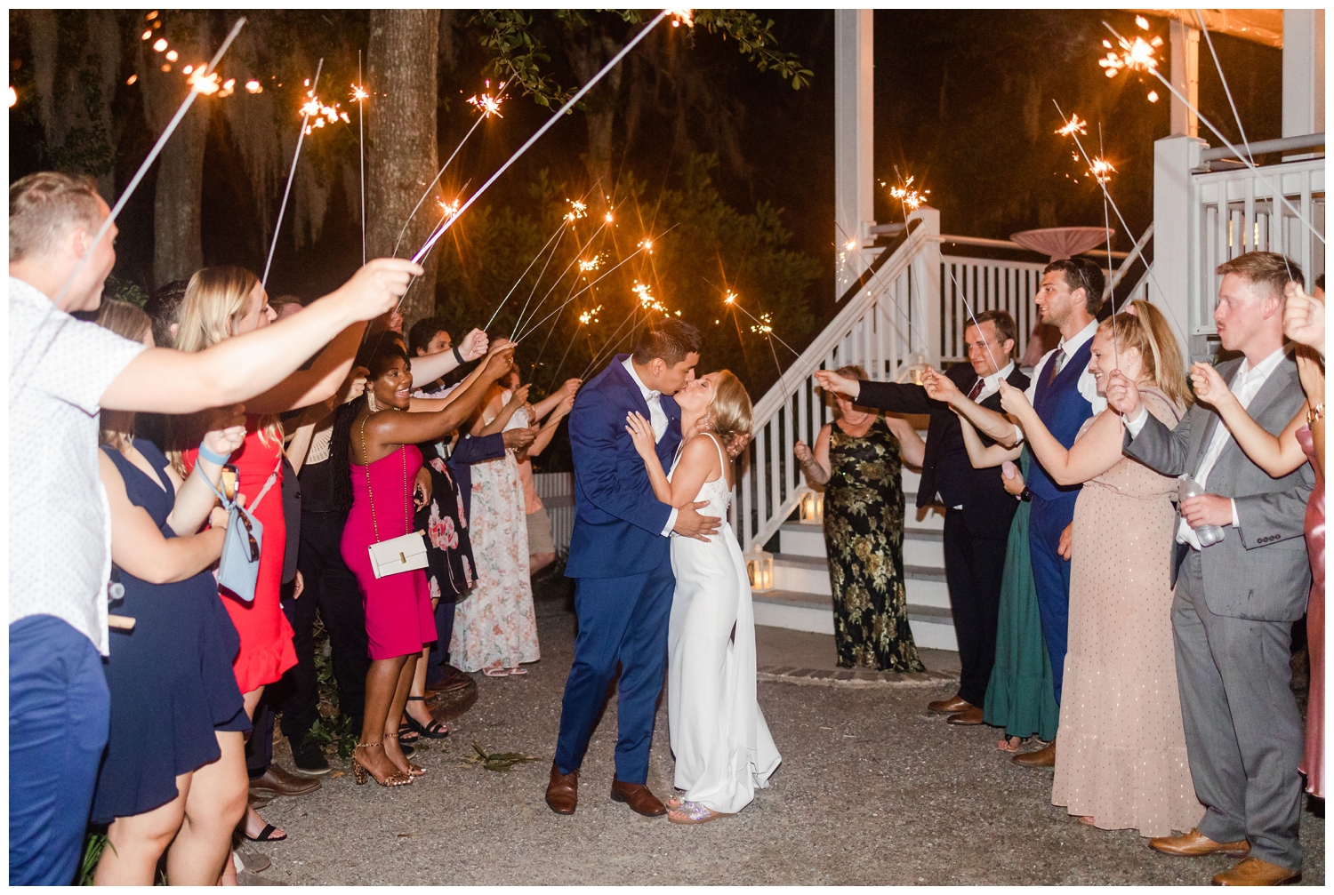 bride and groom kiss during sparkler exit at Creek Club I'On