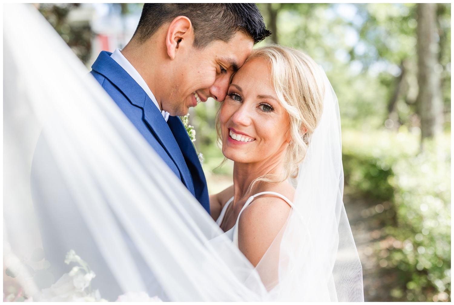 bride and groom portraits with veil swoom