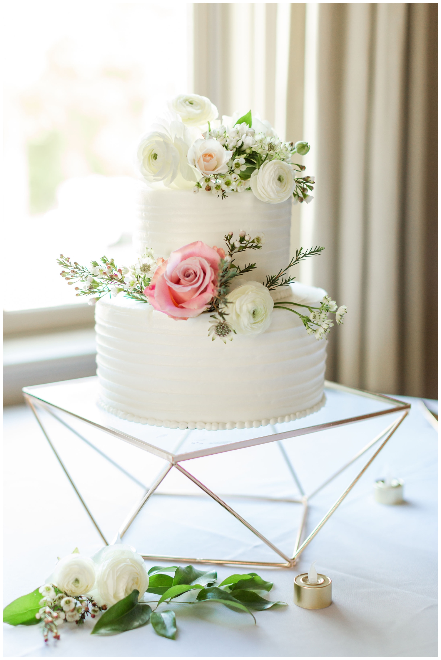 white cake with pink white florals