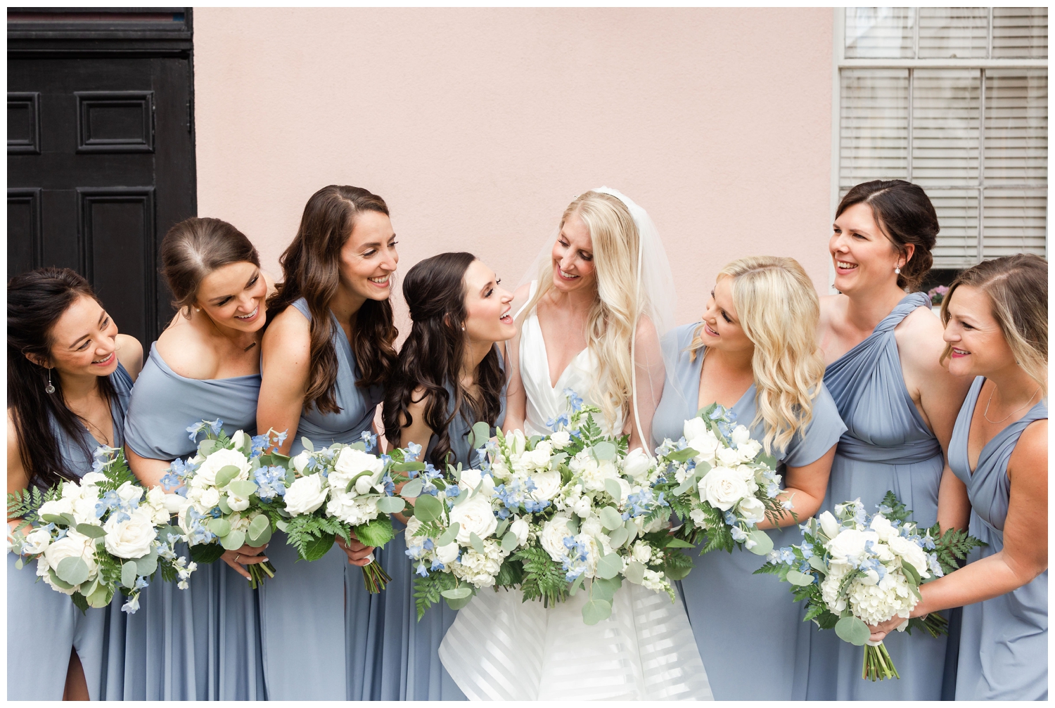bride with bridesmaids with white and blue bouquet