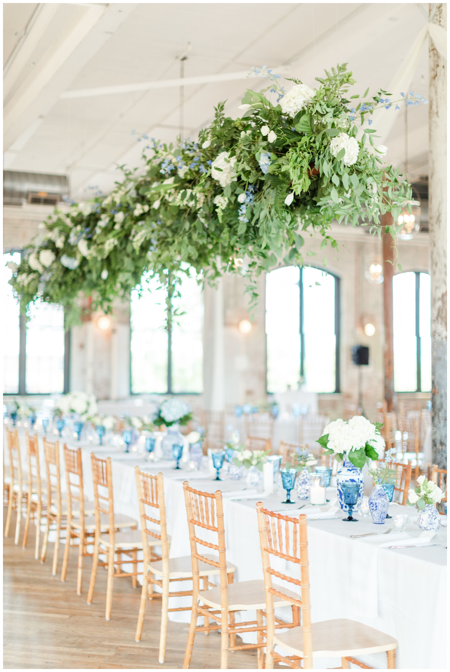 luxury Cedar Room wedding reception florals hanging over head table