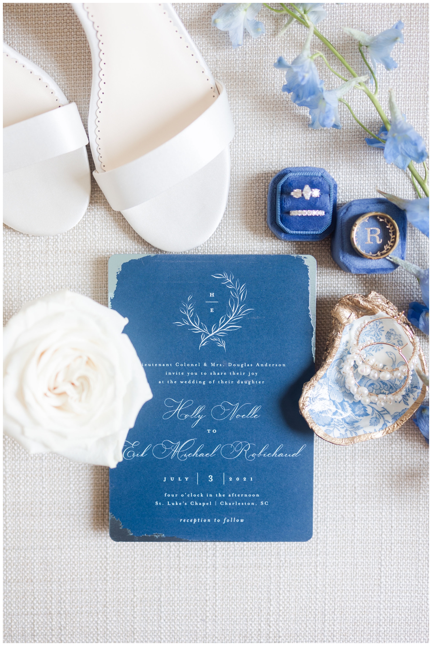 blue invitation flatlay with Bella Belle shoes and blue ring box