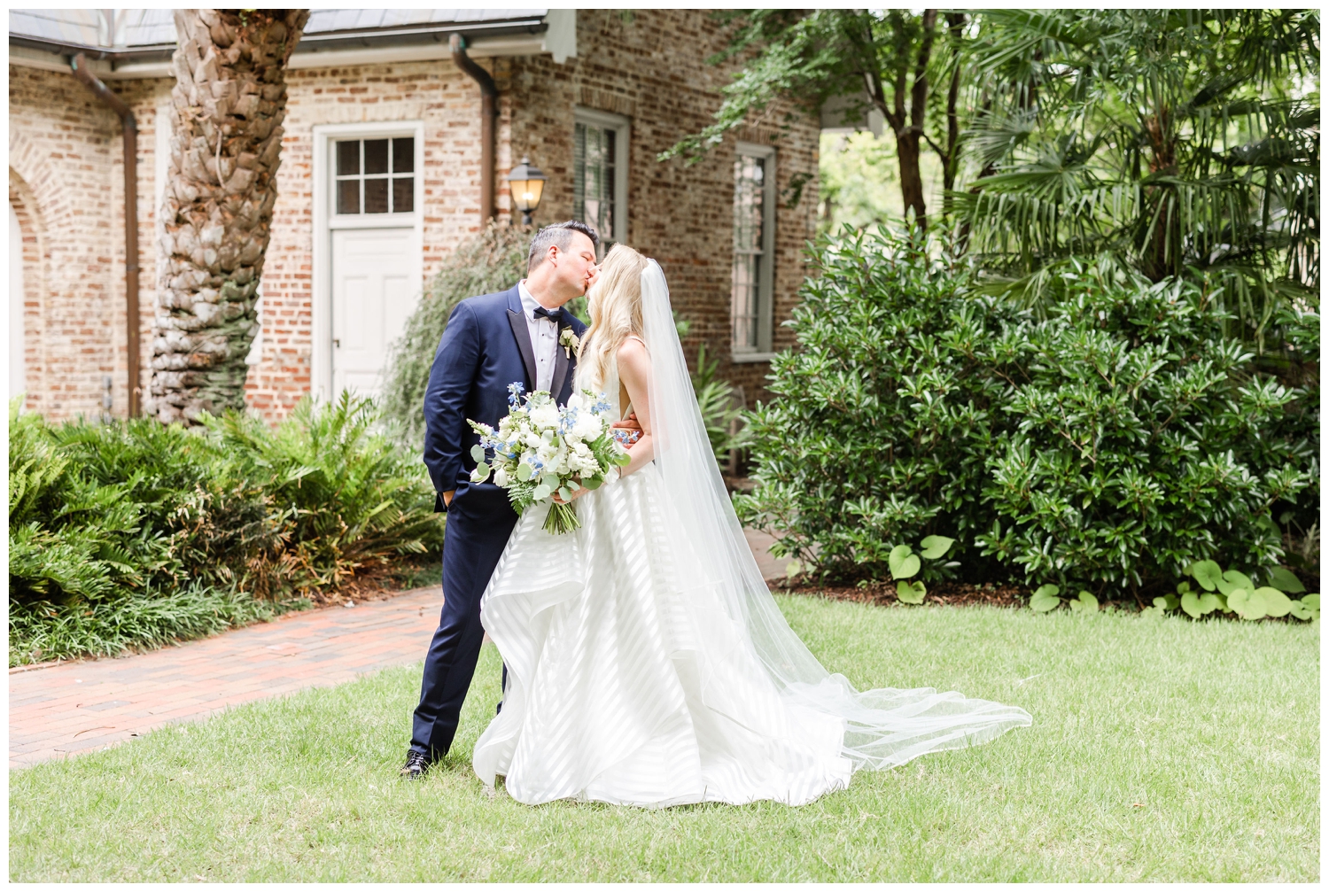 bride and groom kissing portrait on lawn at luxury Cedar Room wedding